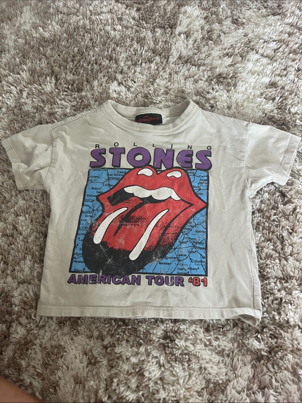 the Rolling Stones Kids Cream Tee with Red Tongue & Blue Map Graphic